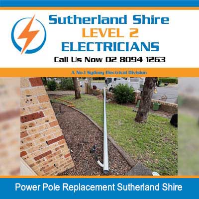 New power pole installed in residential front yard near brick driveway in Sutherland Shire