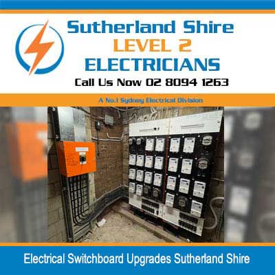 Electrical switchboard upgrades with circuit breaker panel and wiring against orange wall in Sutherland Shire